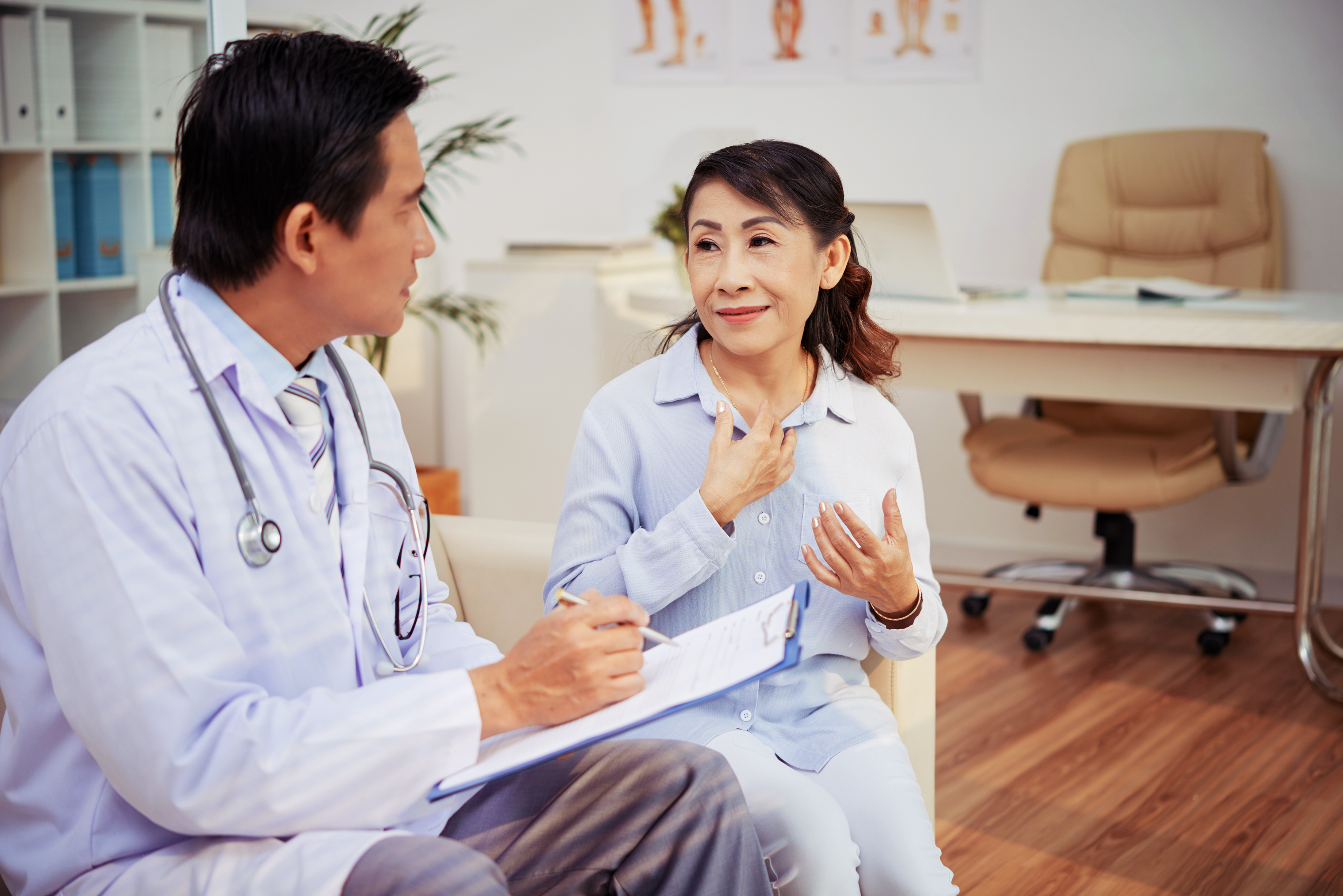 Doctor with patient and clipboard